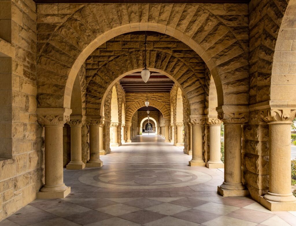 Elegant stone archway corridor at Stanford University, a perfect blend of history and architecture.